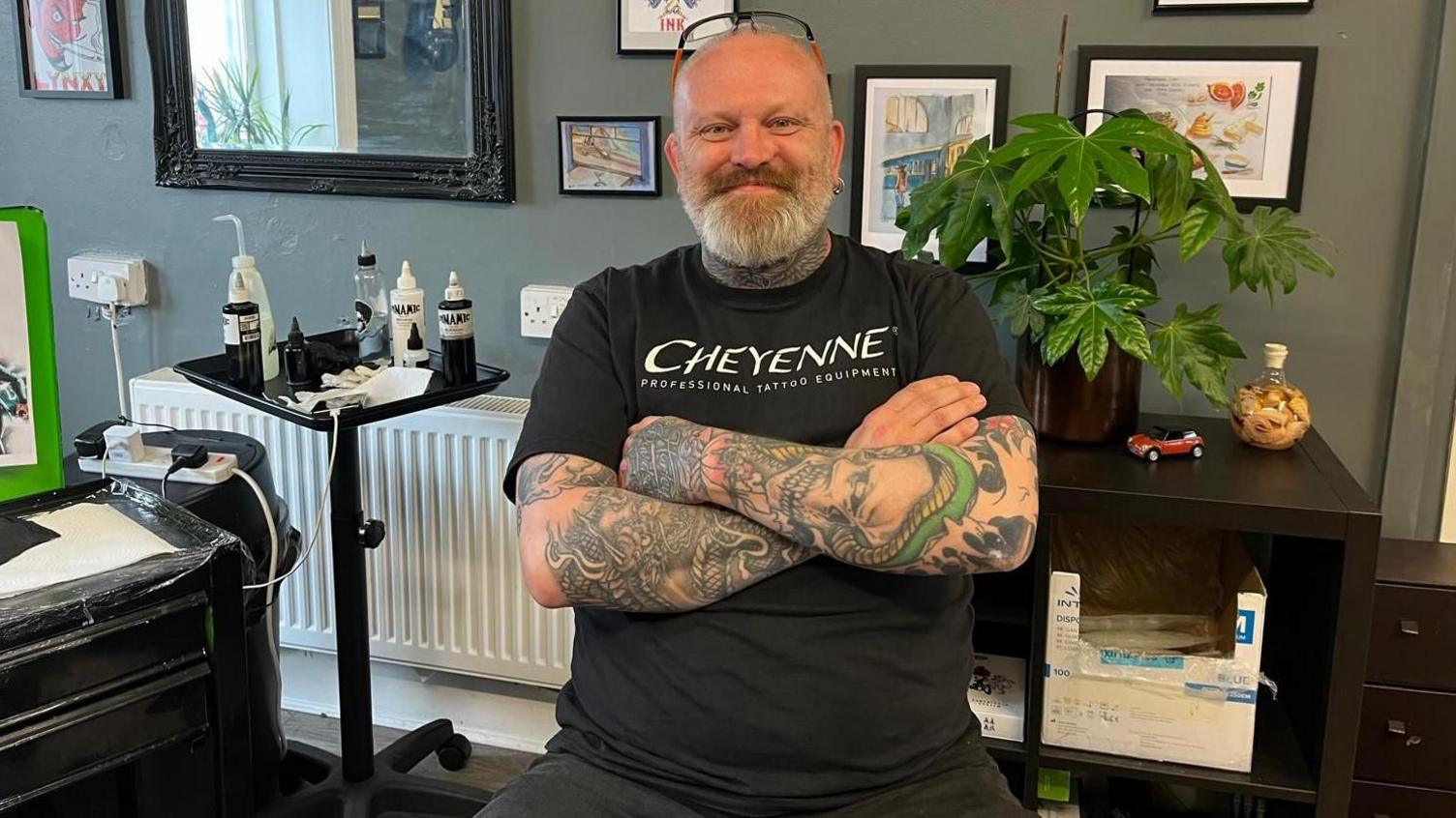 Phil Linskill - a man with a beard and tattoos