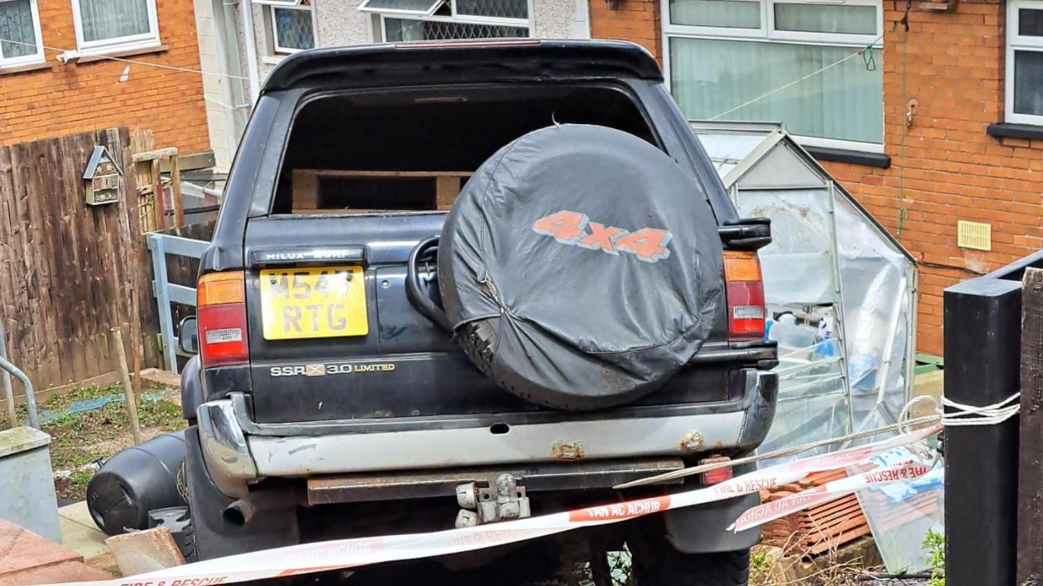 The rear of the Toyota 4x4 stuck at the top of Martin's garden 