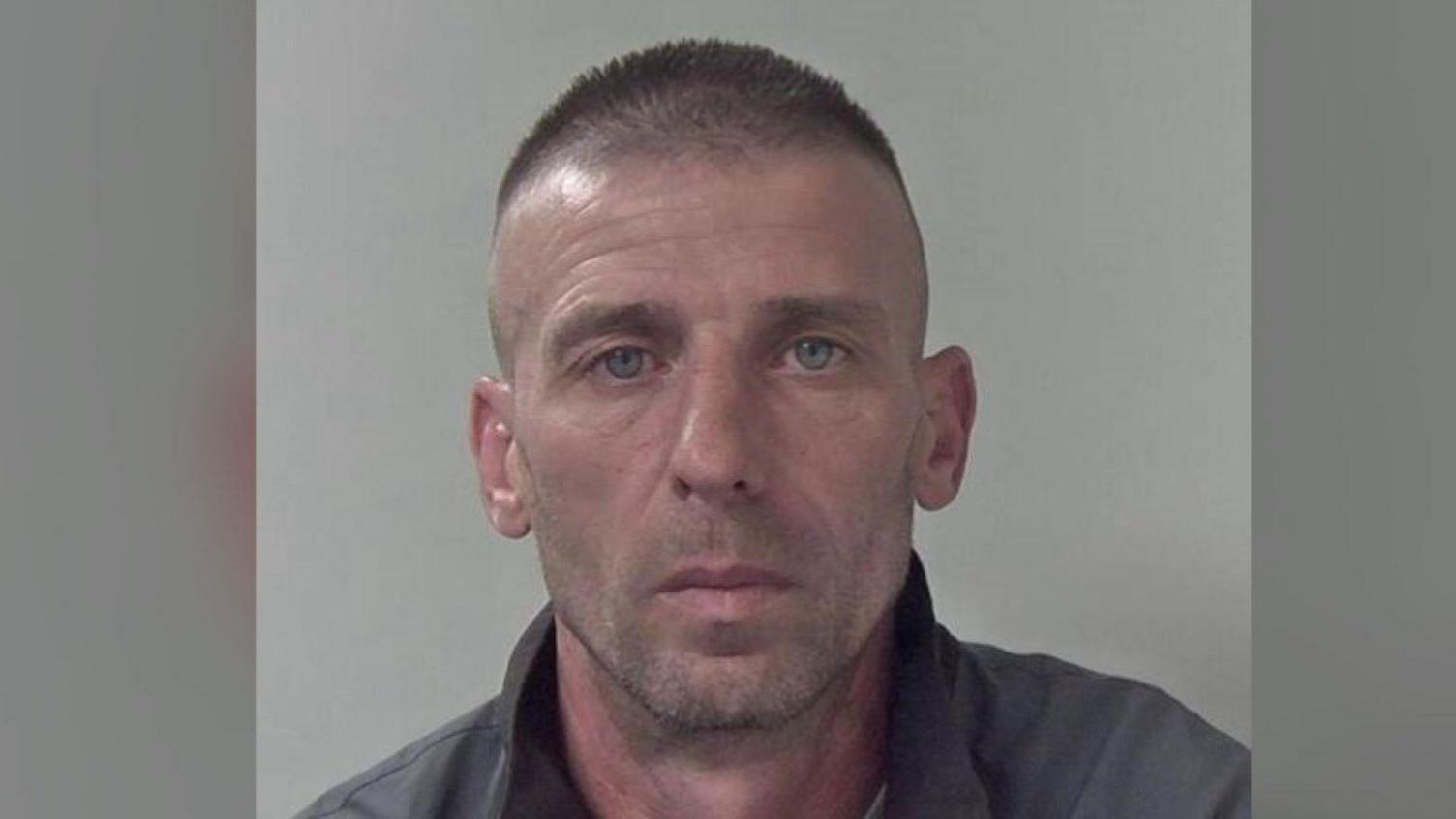 A police mugshot of Sorin-Costinel Ivan. He has grey hair and is wearing a grey fleece.