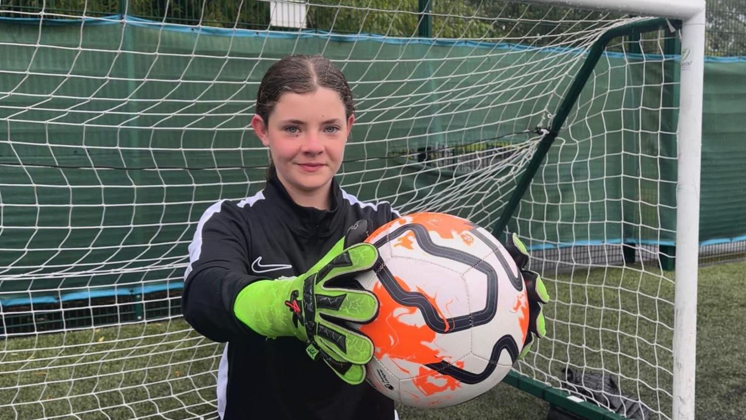 Jess holding a football