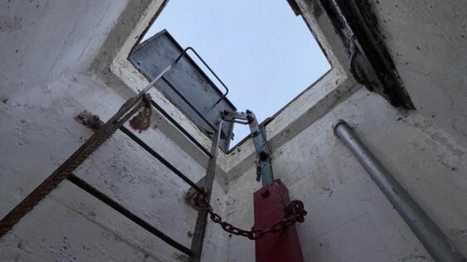 Inside the hatch with a metal ladder leading down