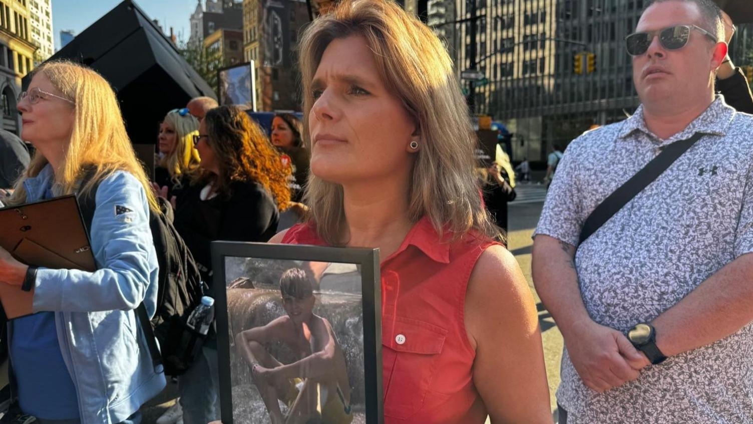 Ellen Roome in New York at the protest with a framed picture of her son