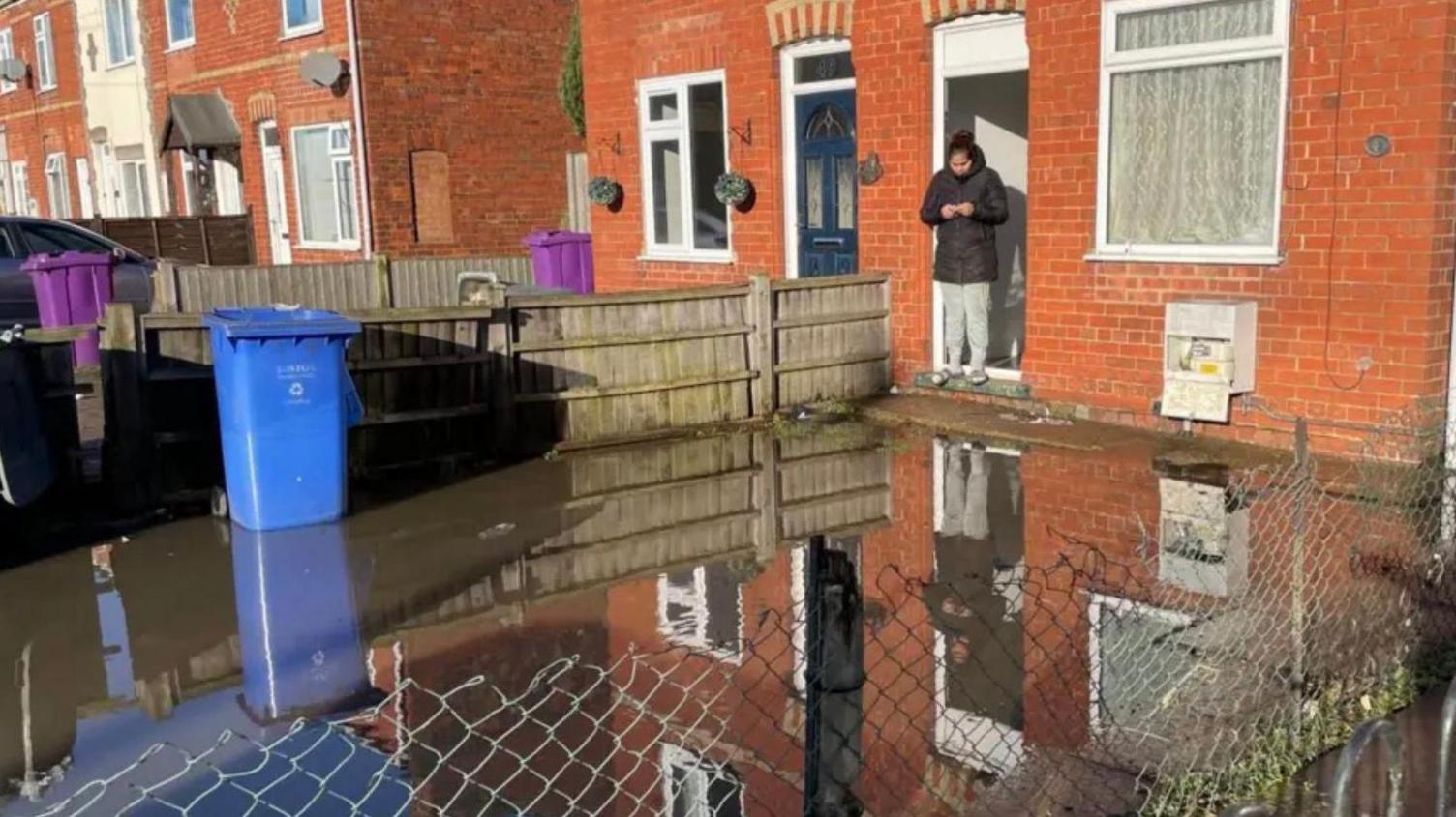 The garden of a house submerged in floodwater