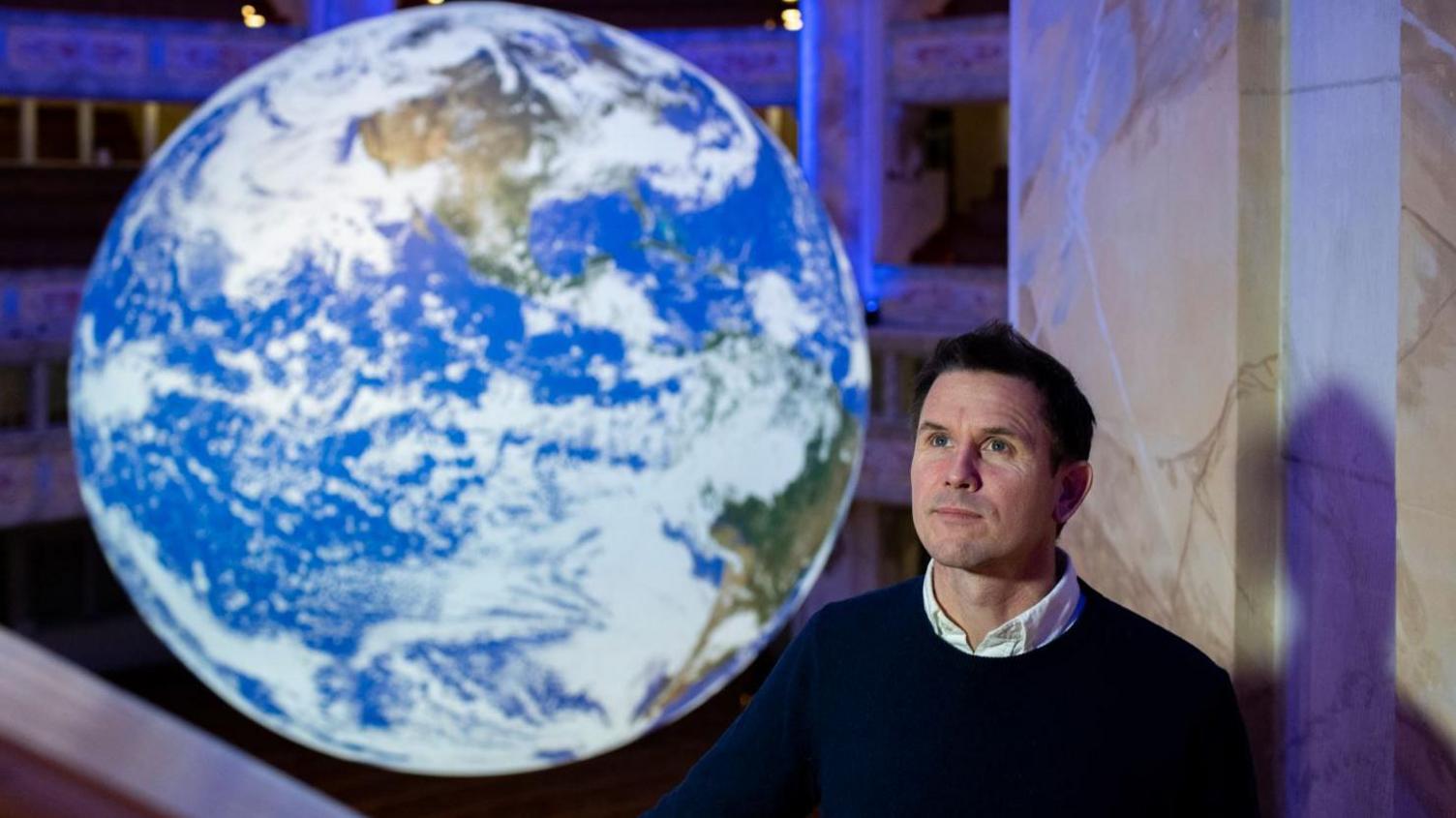 Luke Jerram next to Gaia earth installation