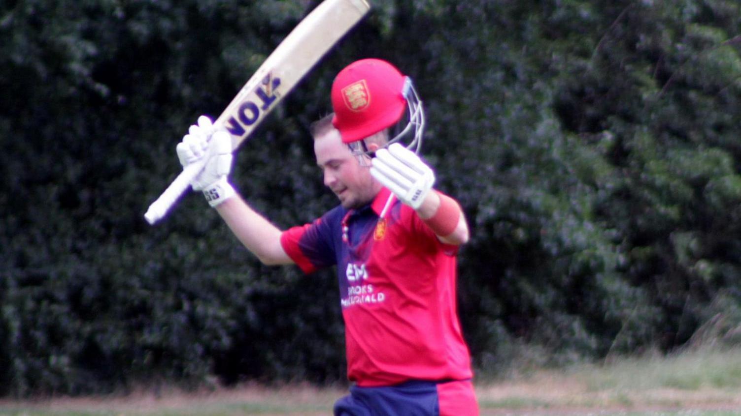 Jersey batter Harrison Carlyon celebrates his century