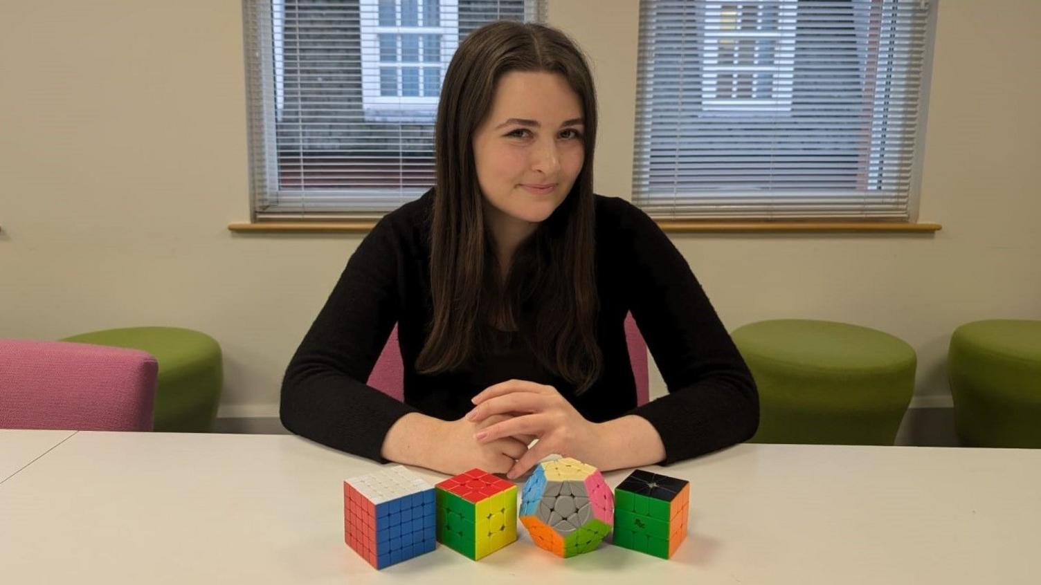 Emily Marshall with a range of Rubik's Cubes