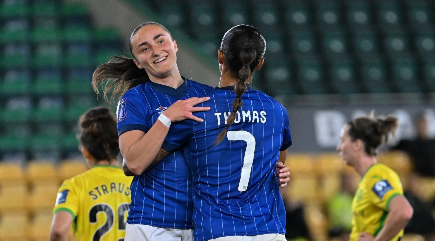 Sophie Peskett embracing Natasha Thomas