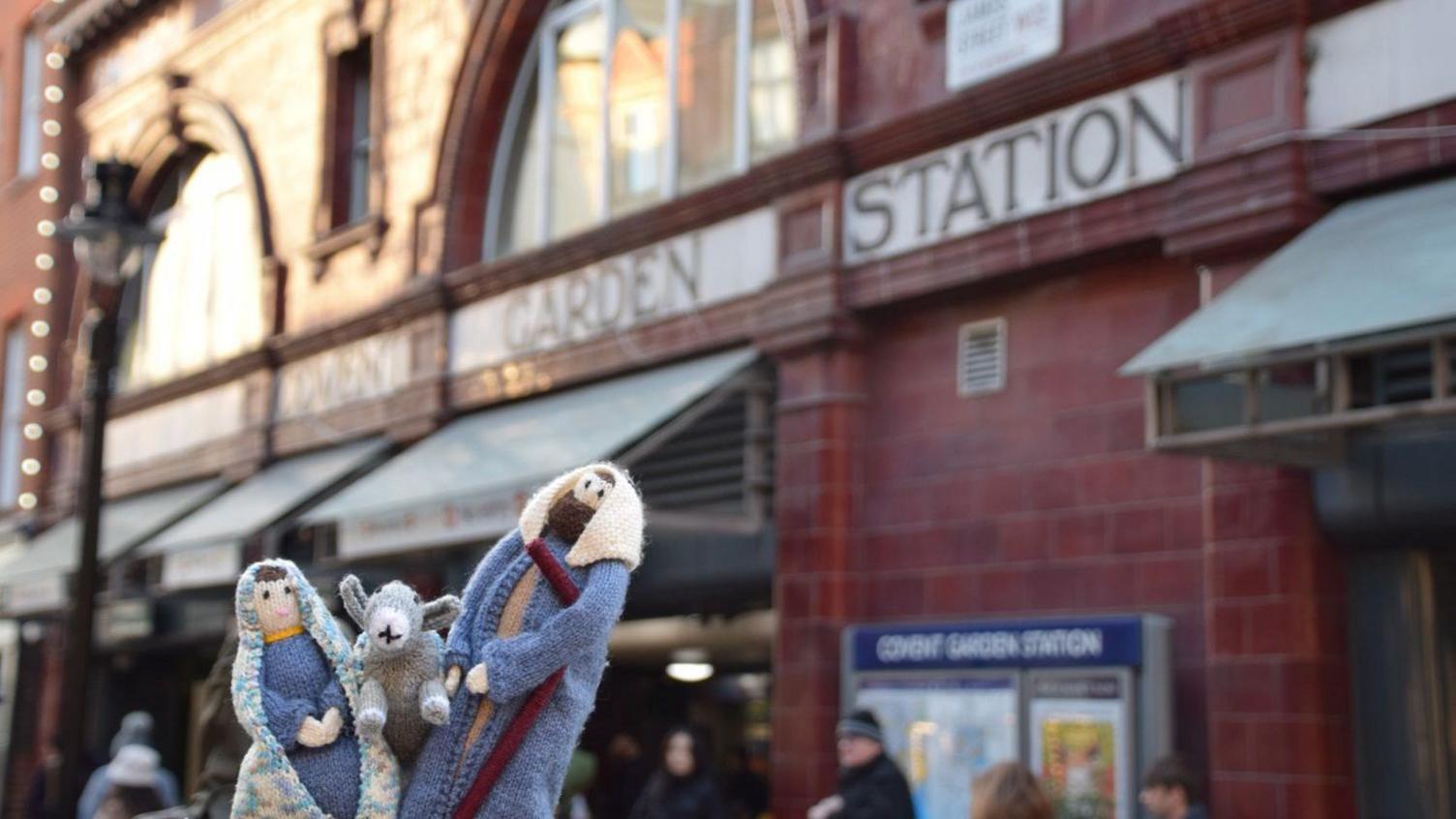 Miniature knitted figurines of Mary, Joseph and a donkey outside Covent Garden Station.