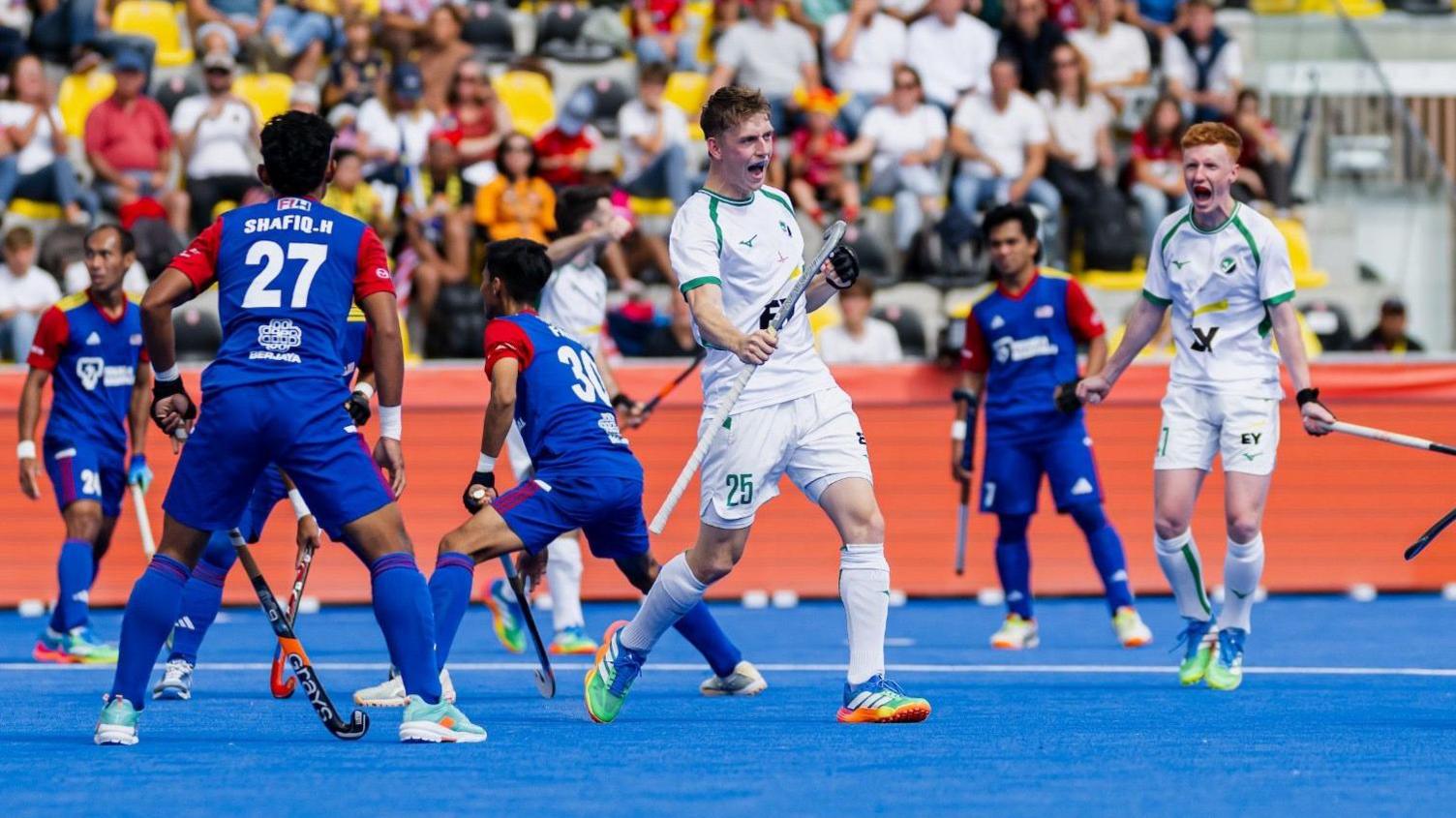 Jonny Lynch celebrates one of his three goals against Malaysia