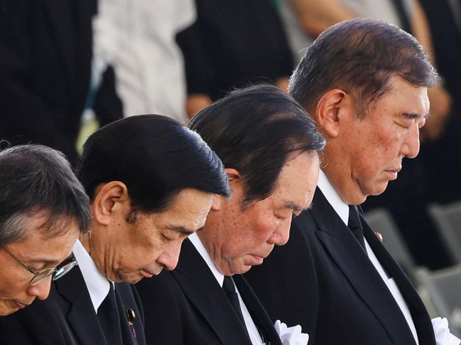 Japan's Prime Minister Shigeru Ishiba joins in the prayers at the ceremony