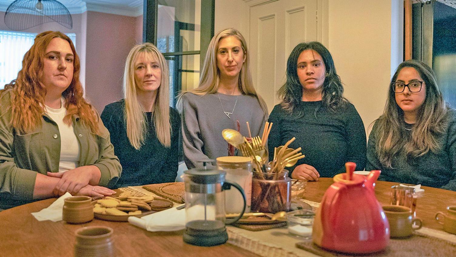 Five bereaeved mothers sitting around a dining room table