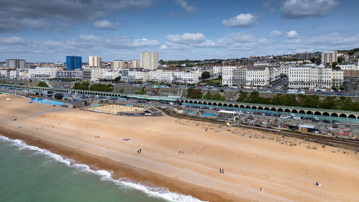 A photograph showing the beach, terrace arches and city beyond