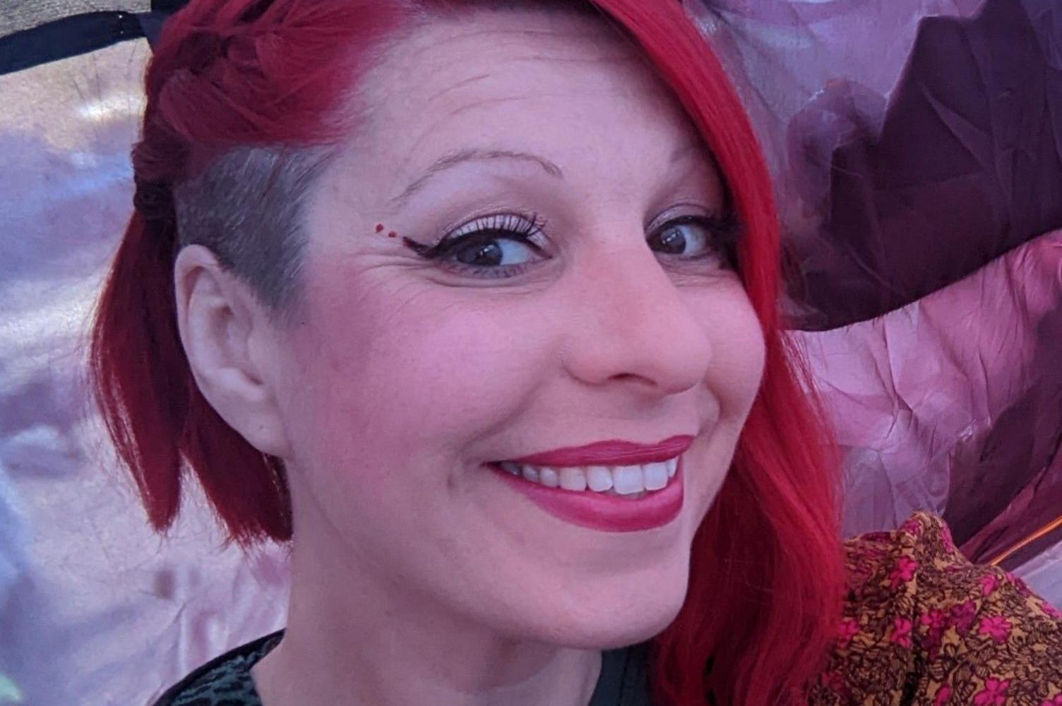 Kirsty Hopley, a woman with red hair, smiles for the camera.