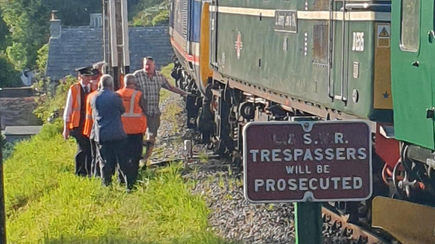 Passengers with derailed train