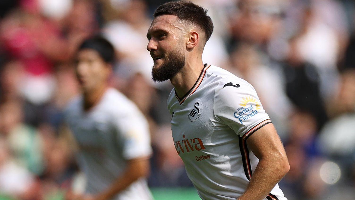 Matt Grimes celebrates scoring a penalty for Swansea