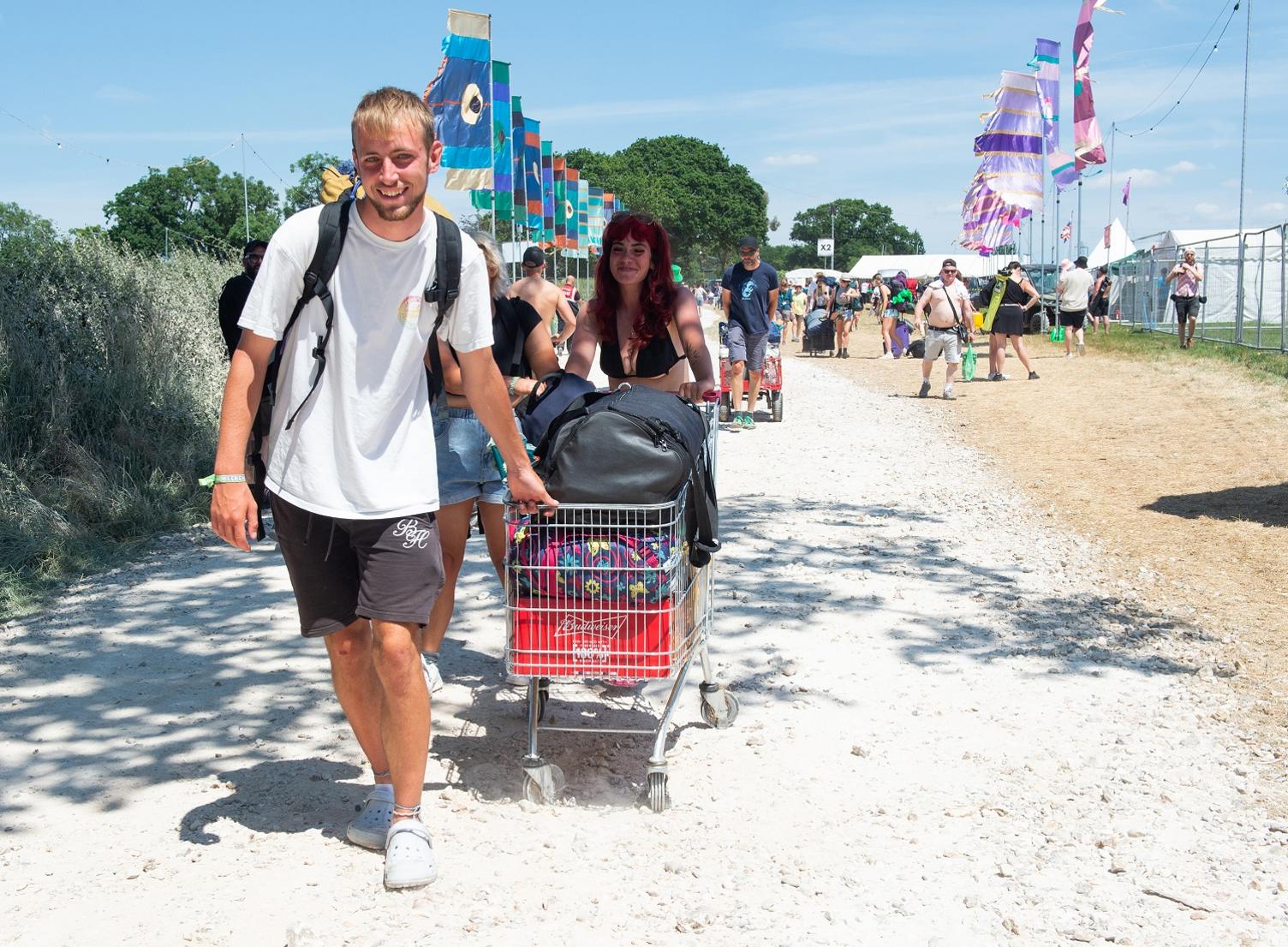 Campers pushing a shopping trolley