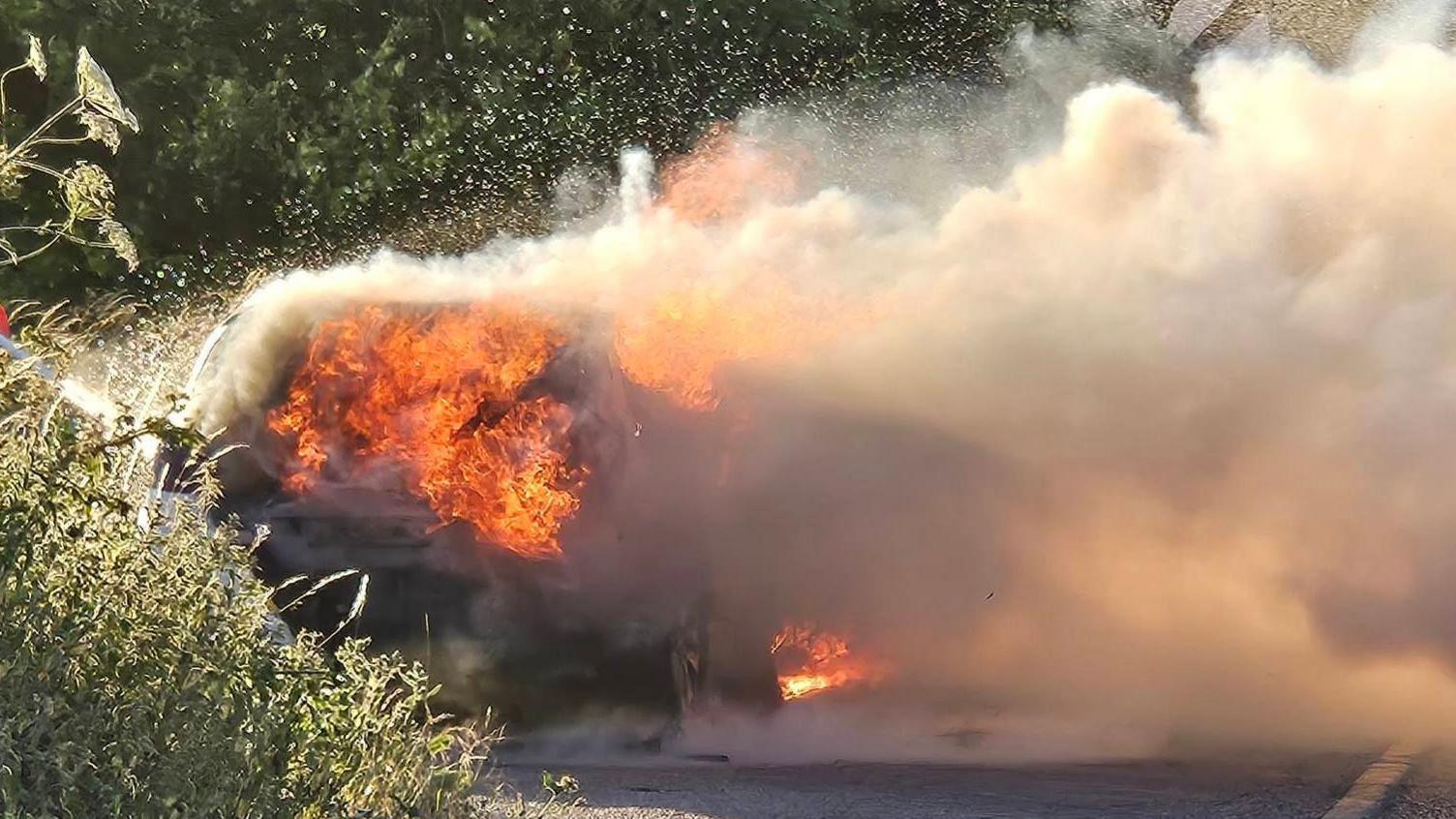 Car on fire with flames and smoke