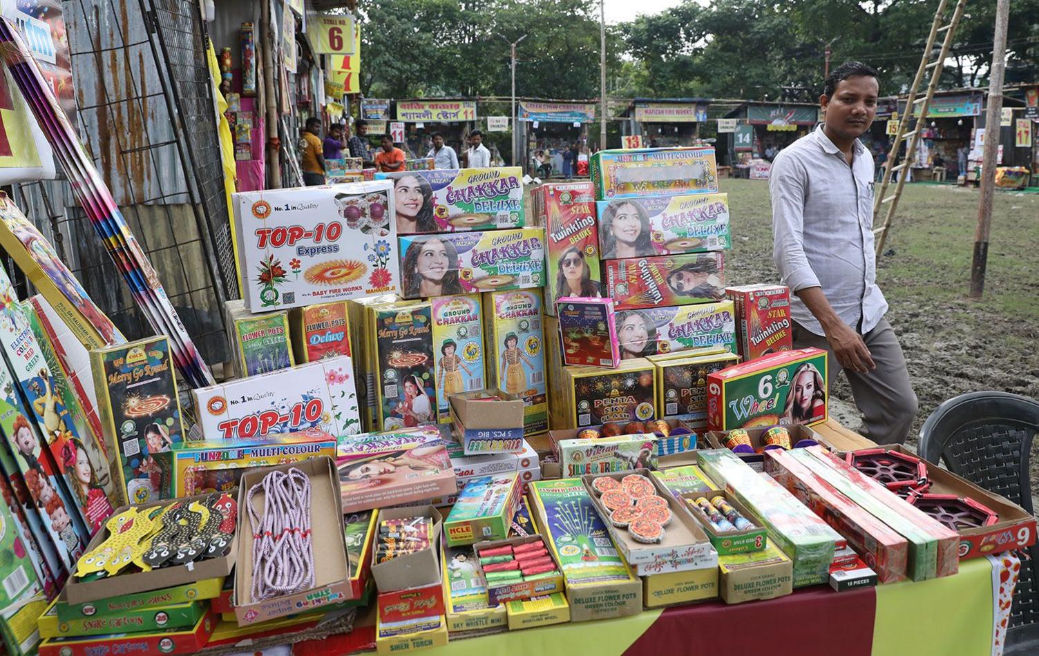 A man walks past a stall at a firecracker fair ahead of the Diwali in Kolkata, on October 29, 2024