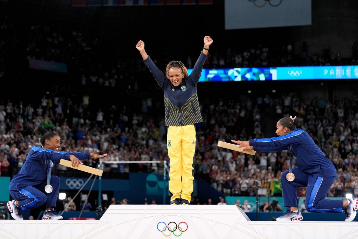 Simone Biles and Jordan Chiles bowing down to Brazilian superstar Rebeca Andrade at the Paris 2024 Olympics.