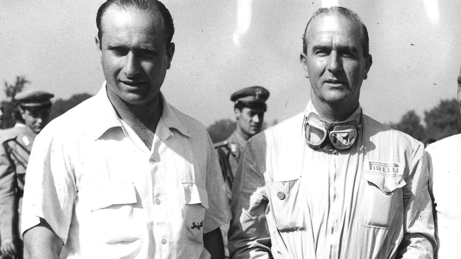Juan Manuel Fangio and Giuseppe Farina pose for photographs before the 1950 Italian Grand Prix