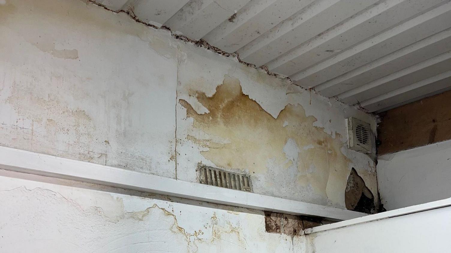 Water damage on the walls of the scout building