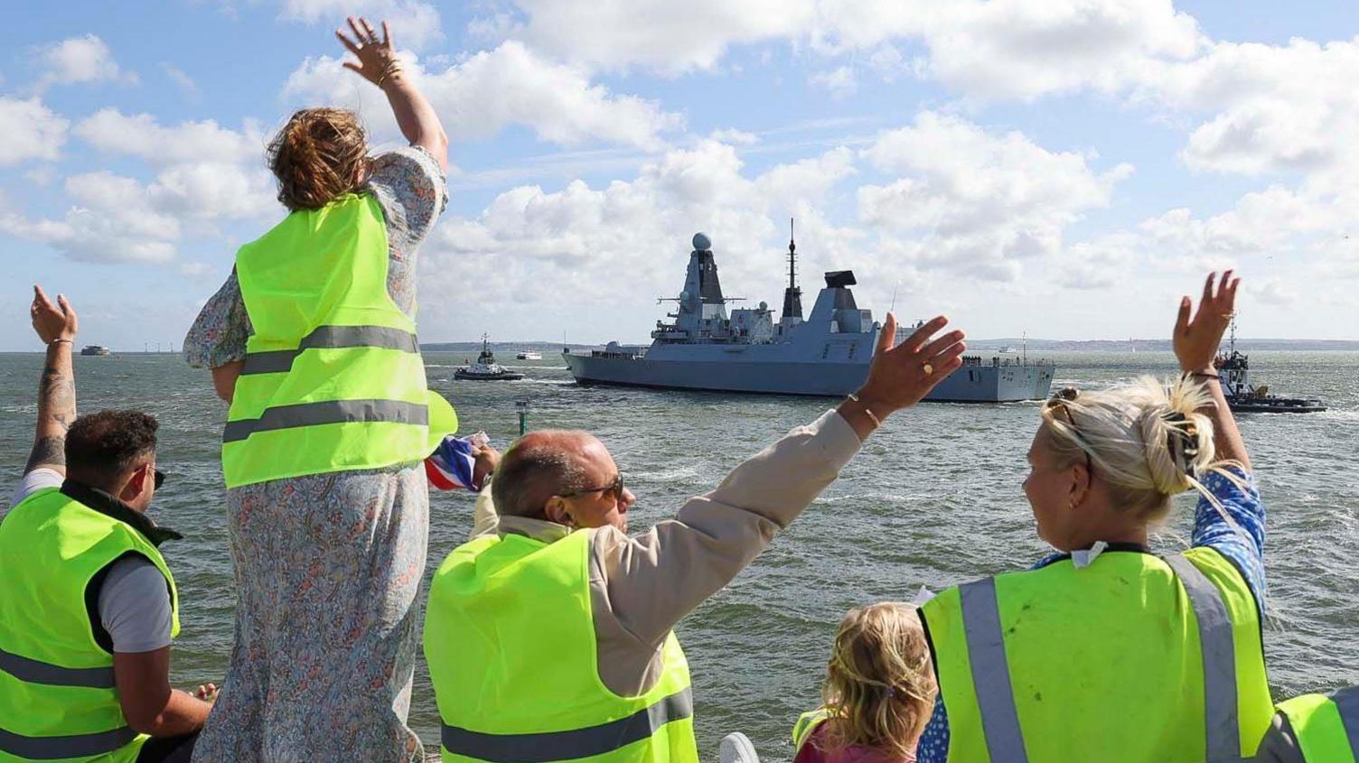 People waving off HMS Duncan as it sets off from Portsmouth