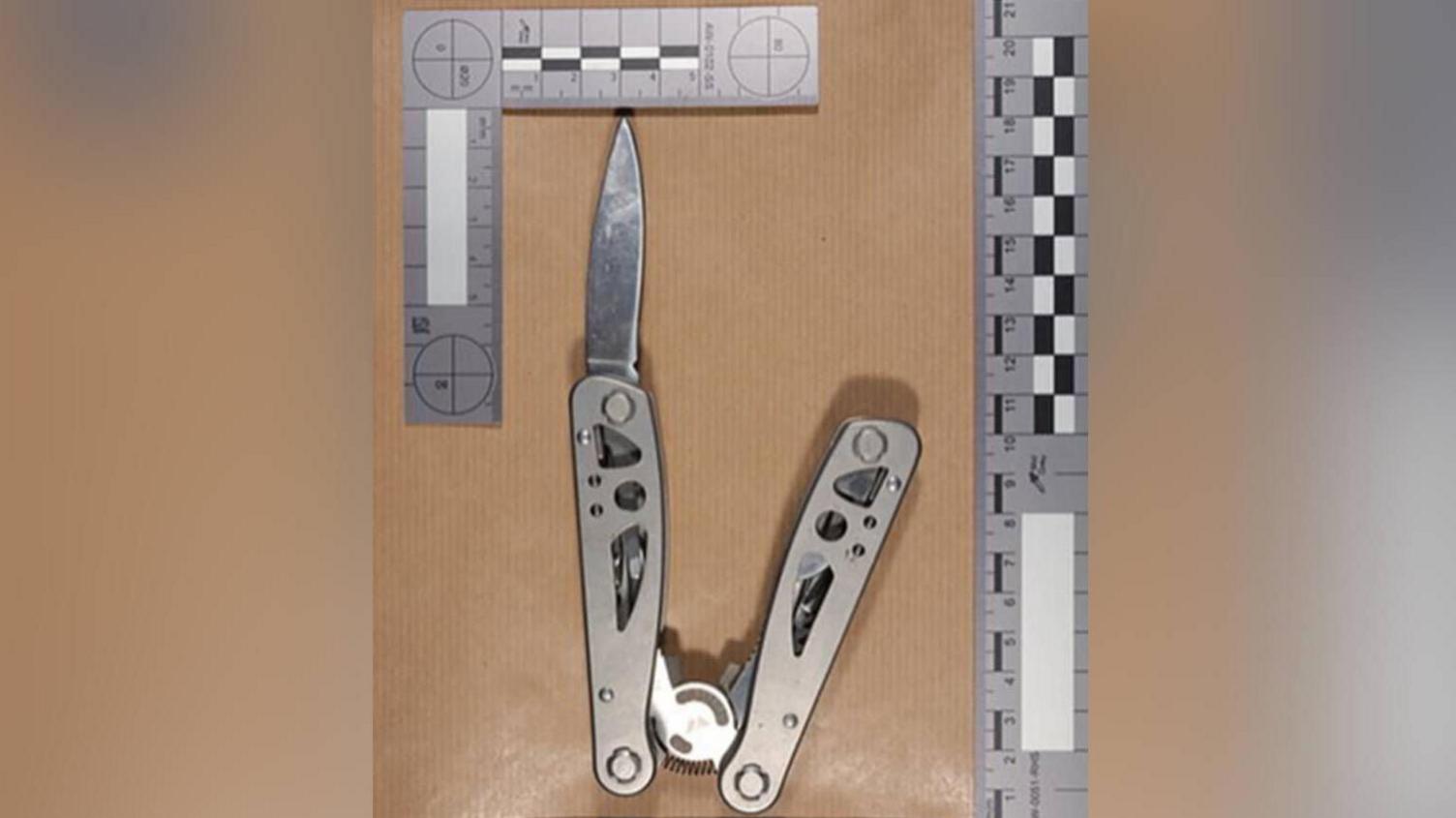 The multi-tool knife used by the teenager, pictured alongside a ruler along the top and bottom. The blade is protruding out of the silver metal case.