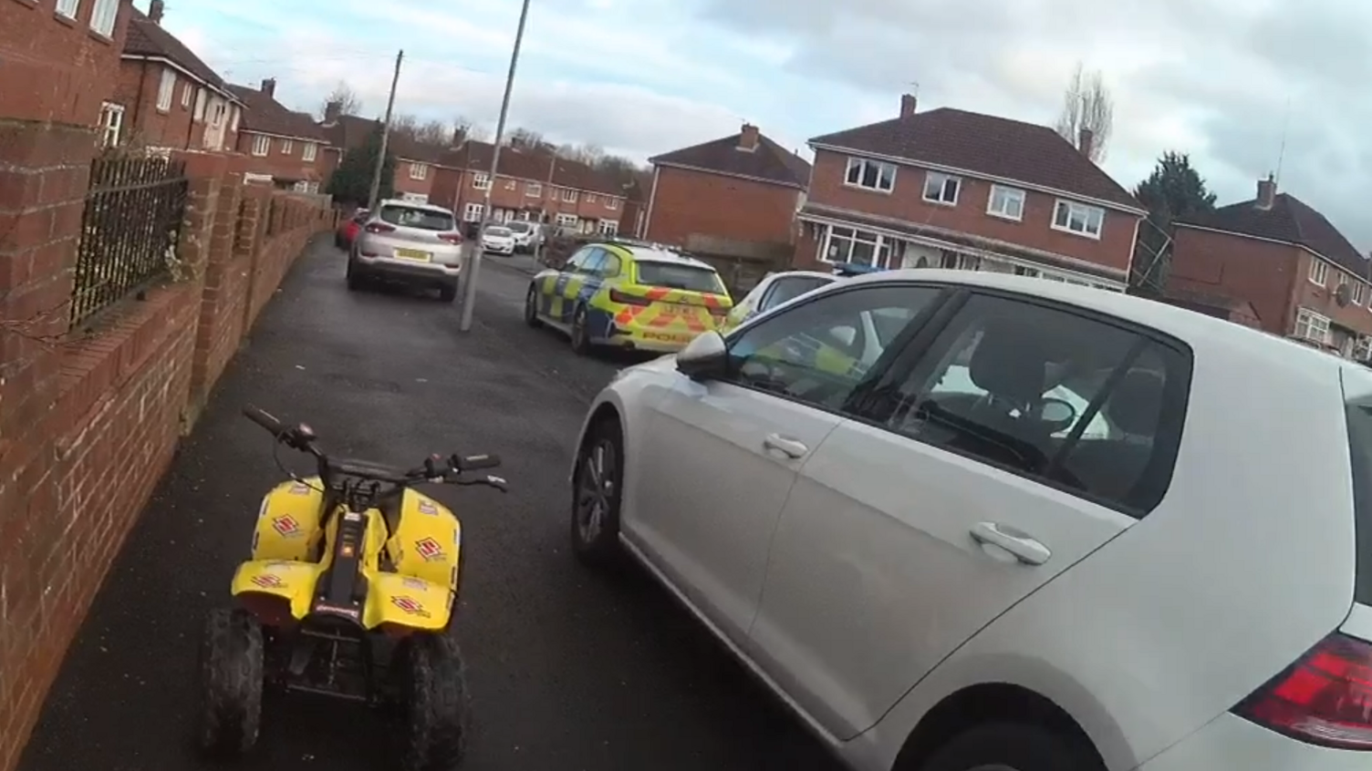 Quad bike surrounded by police cars