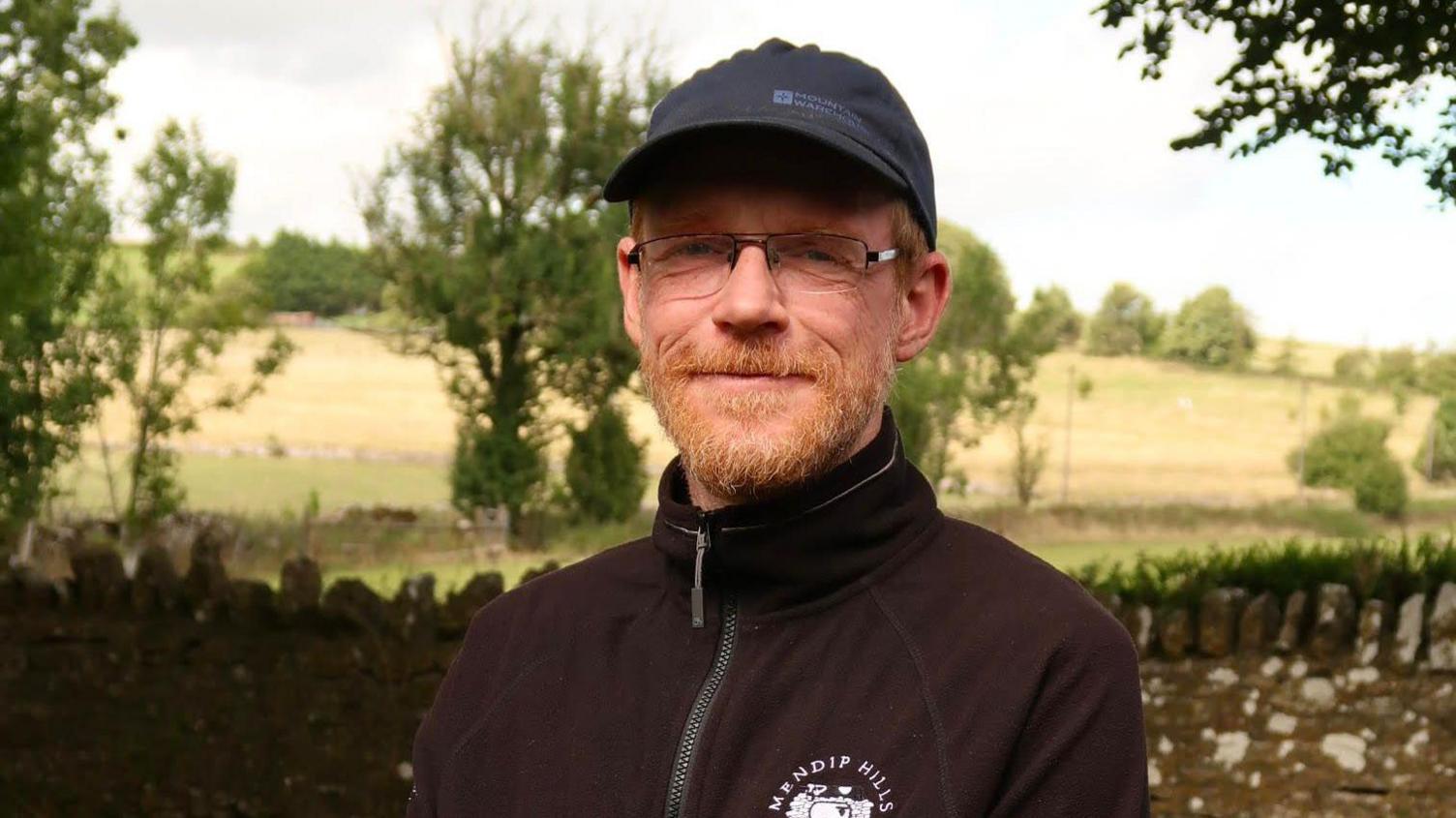 Ecologist Nathan Orr standing outside in the Somerset countryside