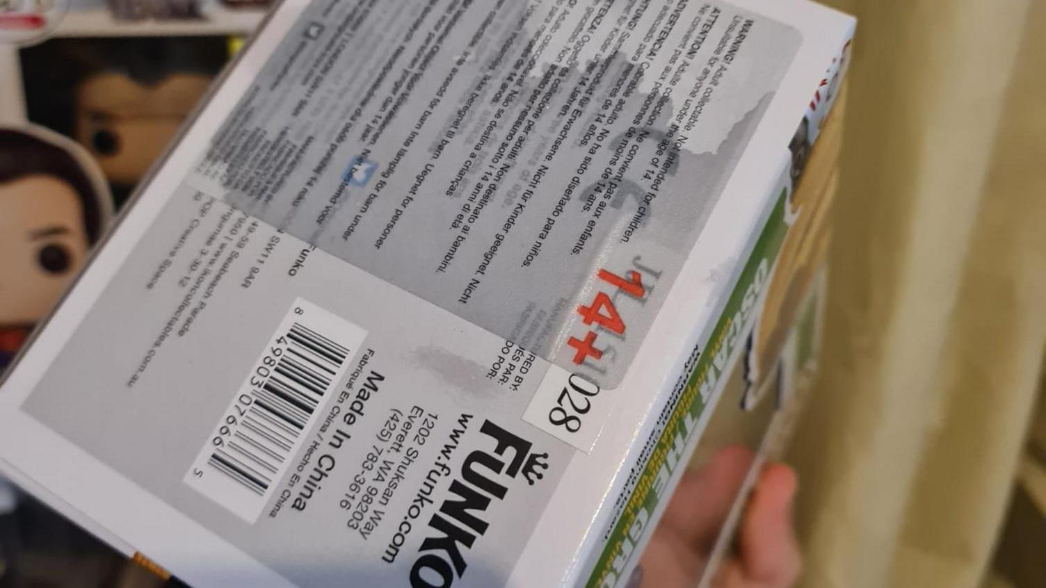 The packaging of a Funko pop model. It is clearly soaked with water.