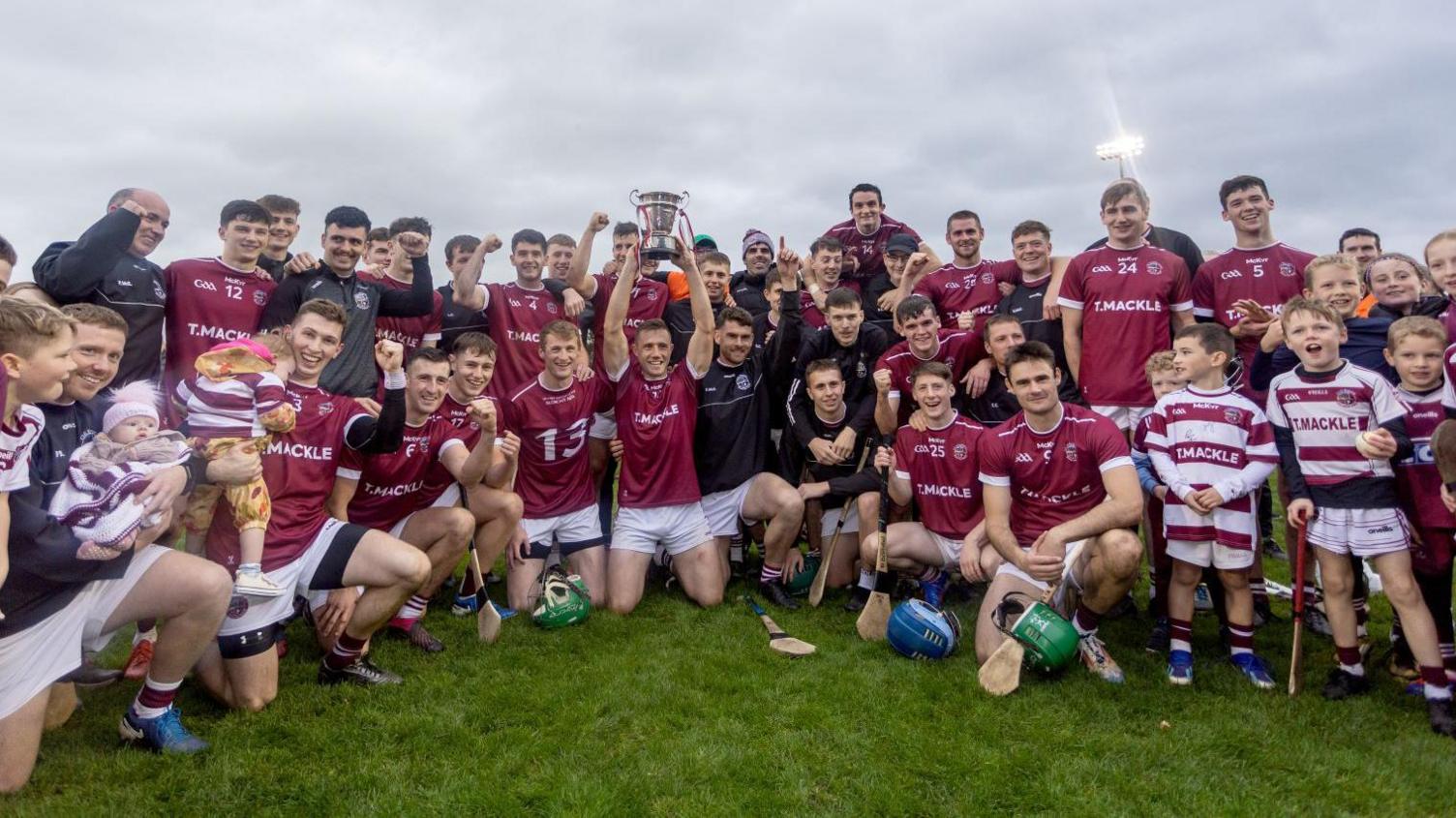 Slaughtneil players celebrate with the cup