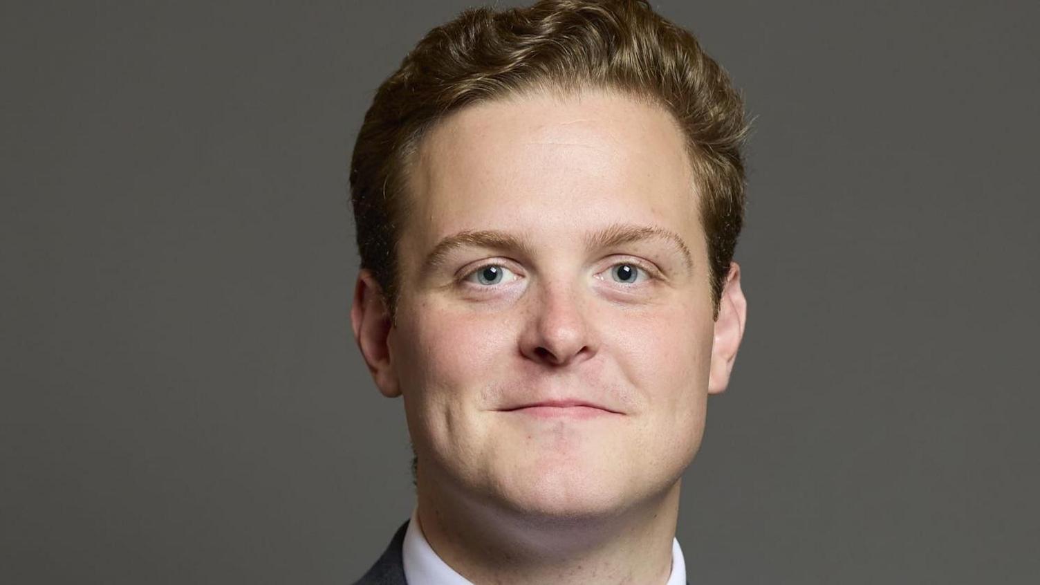 Oliver Ryan MP for Burnley, wearing a suit and white shirt, looking straight ahead at the camera.