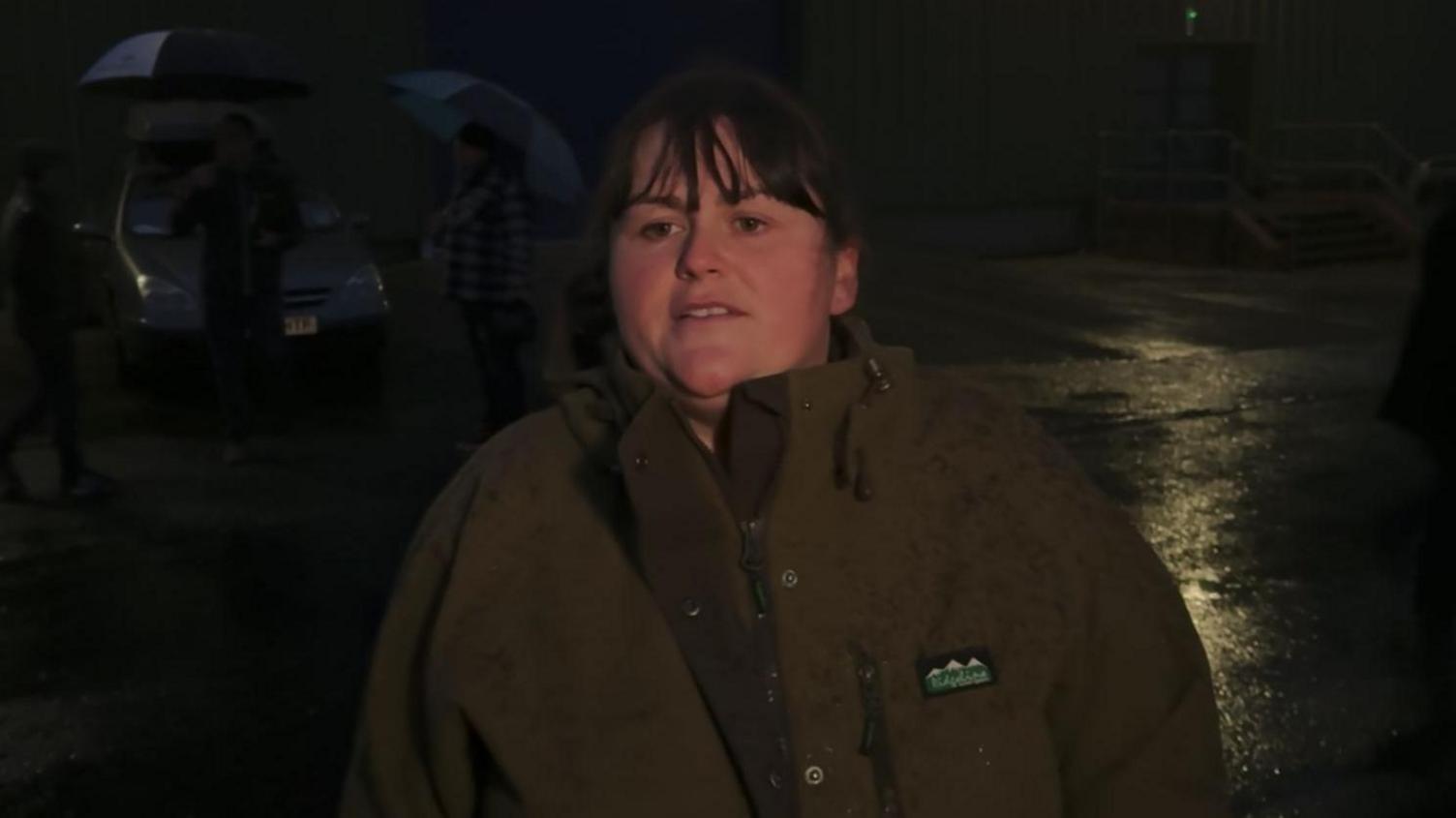 Jessica Copper stood outside in a car park in the early hours of the morning, wearing a wax jacket