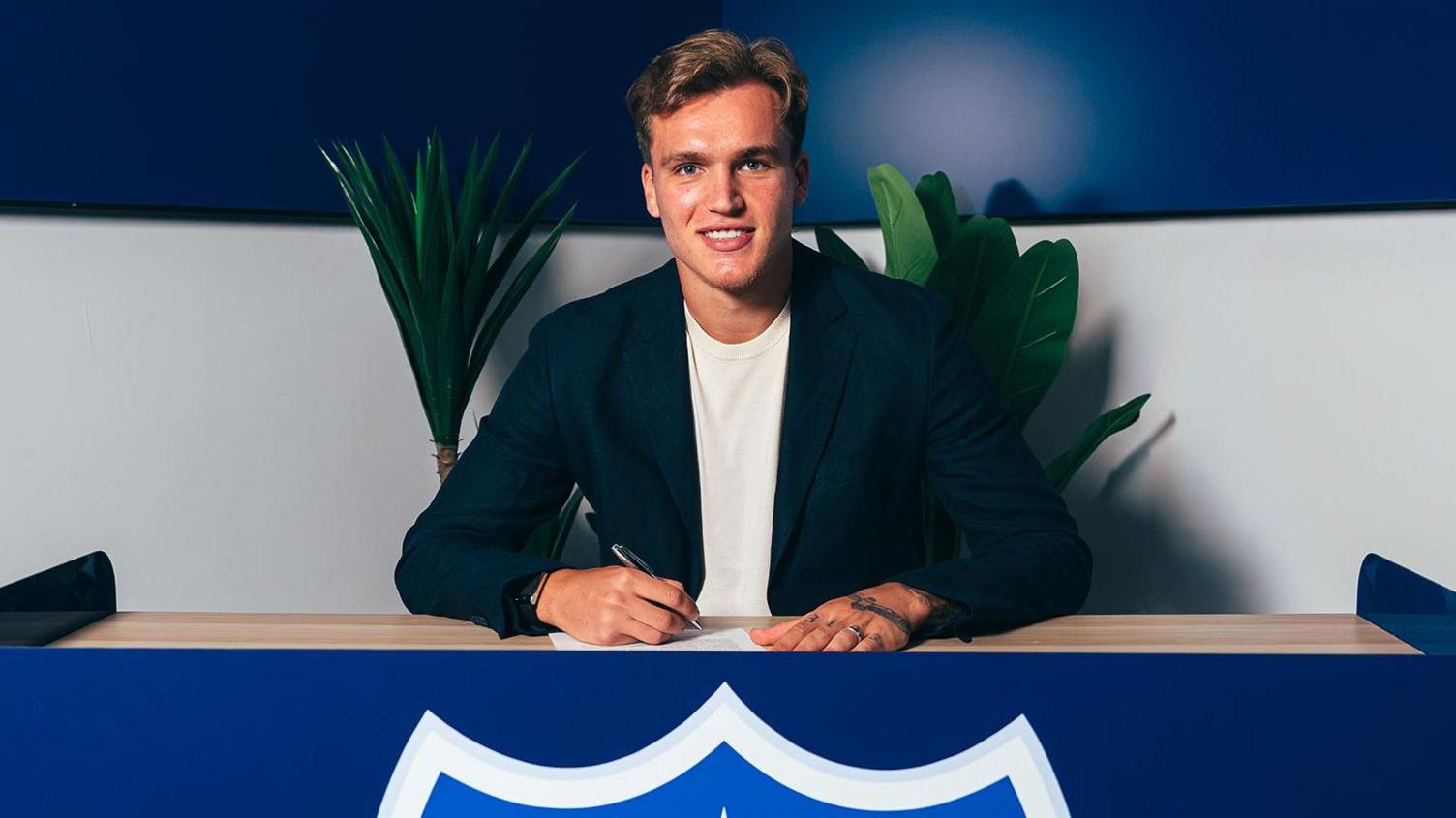 Marko Milovanovic poses for a photo after signing for Portsmouth