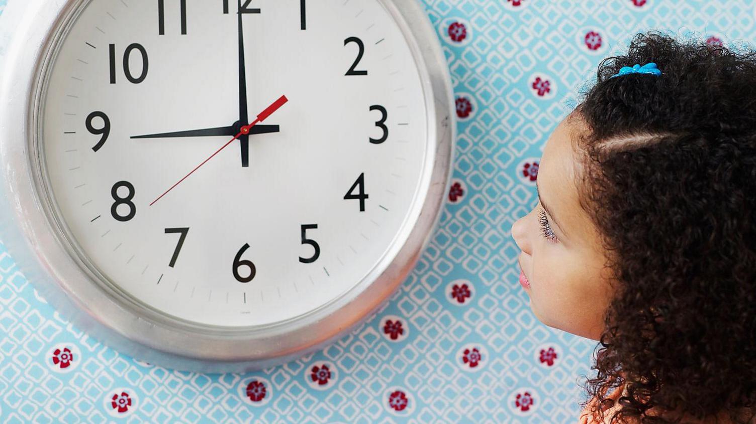 Girl looking at clock 