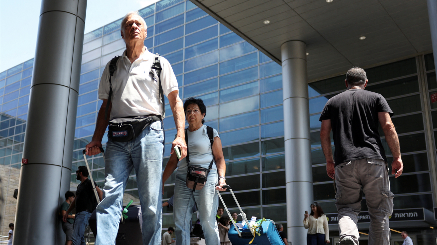 Israeli nationals walk at Ben Gurion International airport