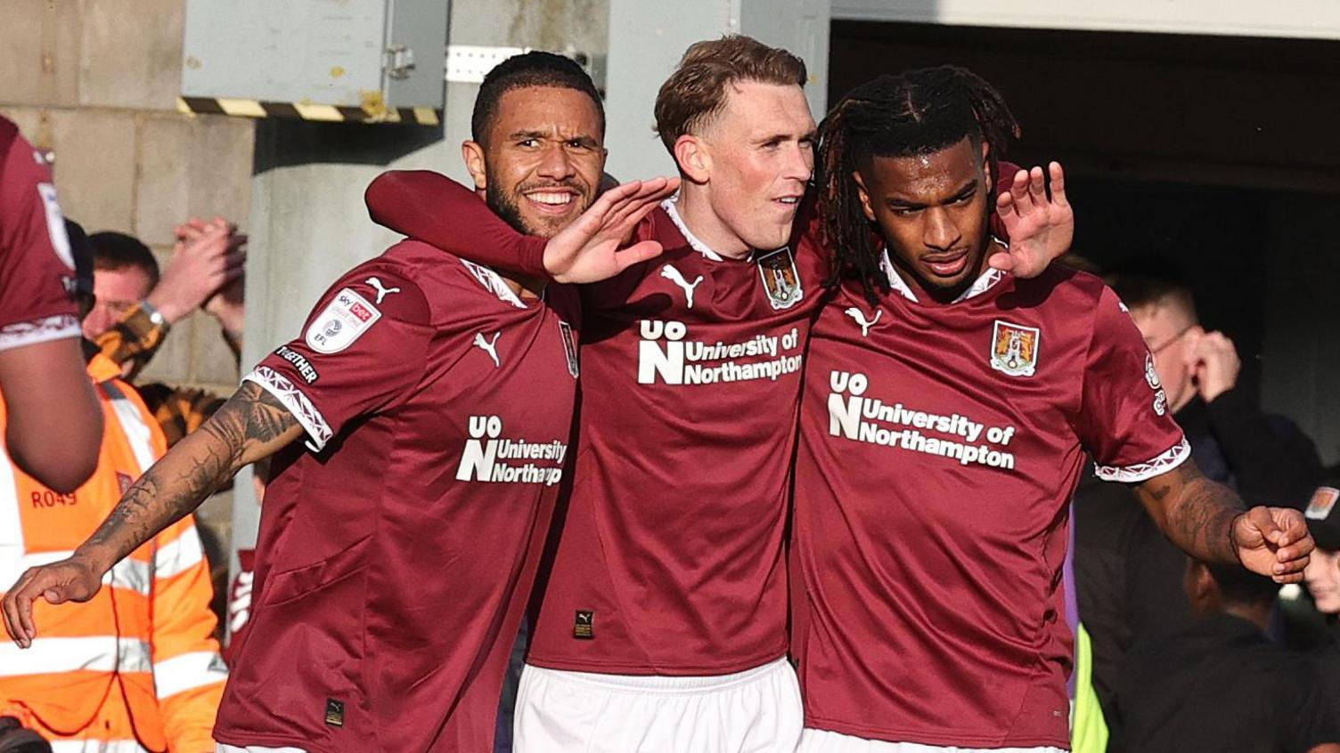 Mitche Pinnock celebrates his goal with team-mates Tyler Roberts and Akin Odimayo 