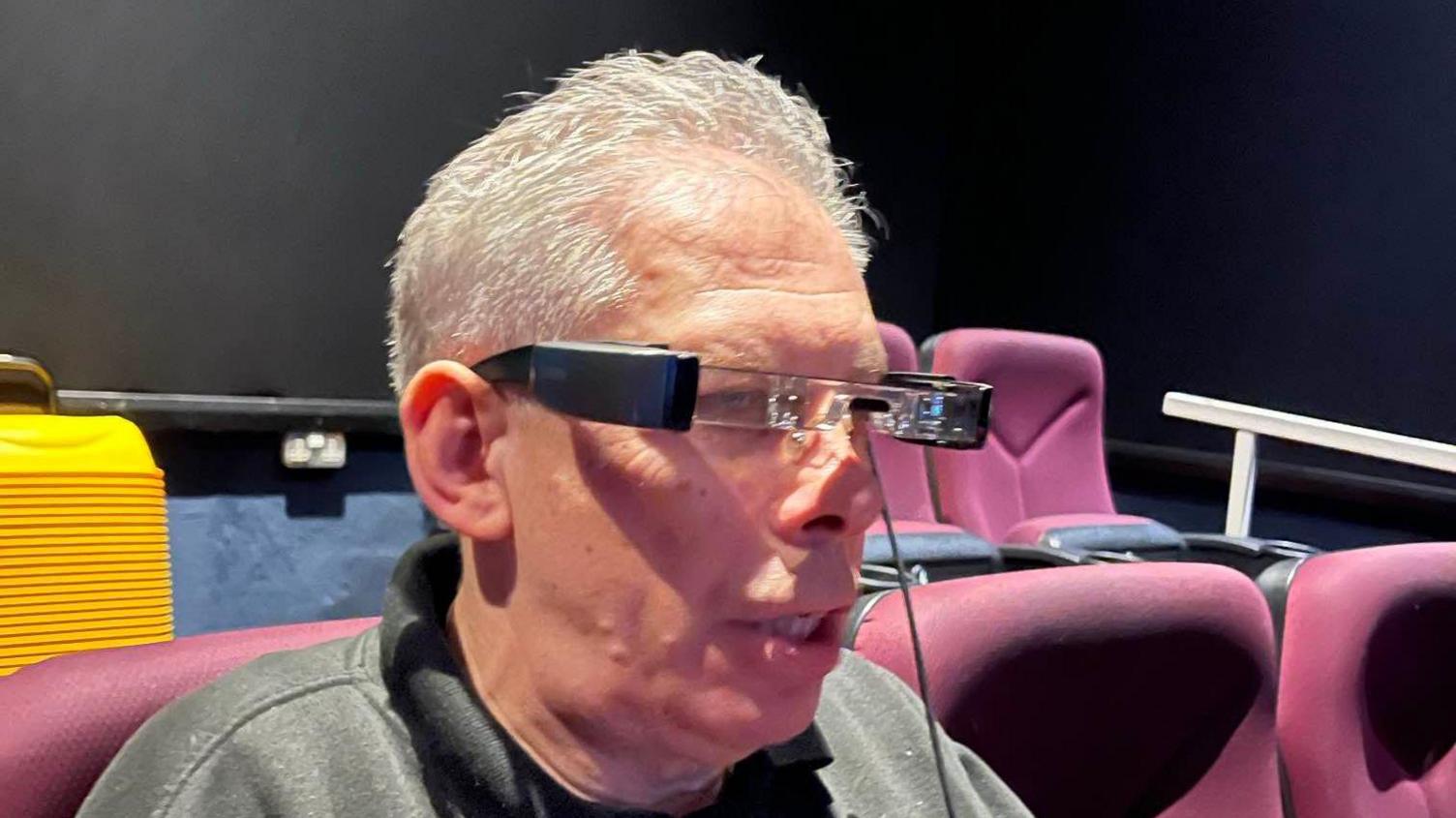 Owner Robert Johnson demonstrates the Watchword subtitle glasses in screen one of The Kavanagh Cinema, Herne Bay