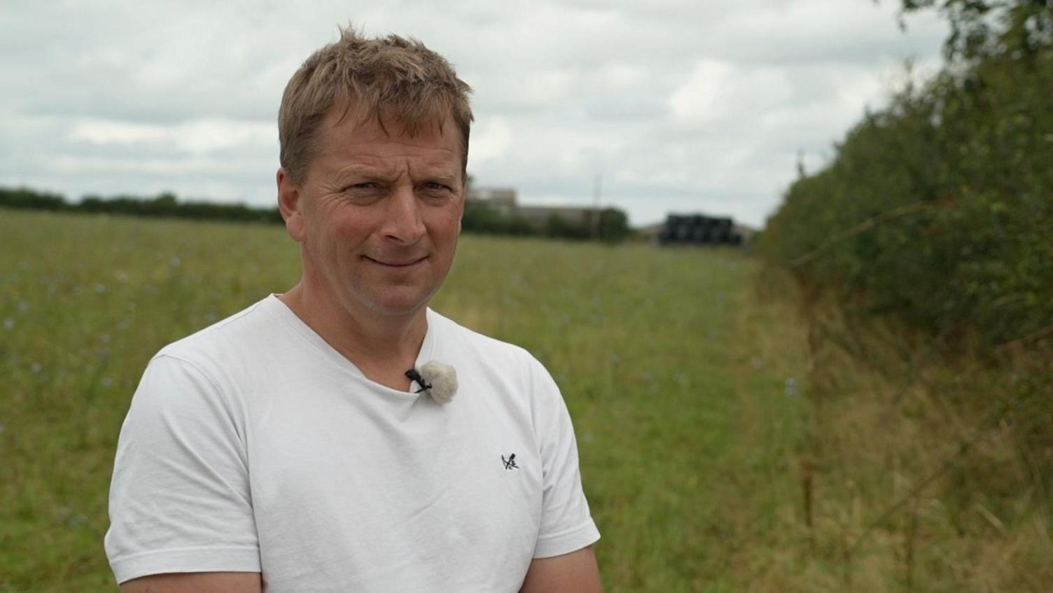 Farmer Richard Dormor standing by a hedge