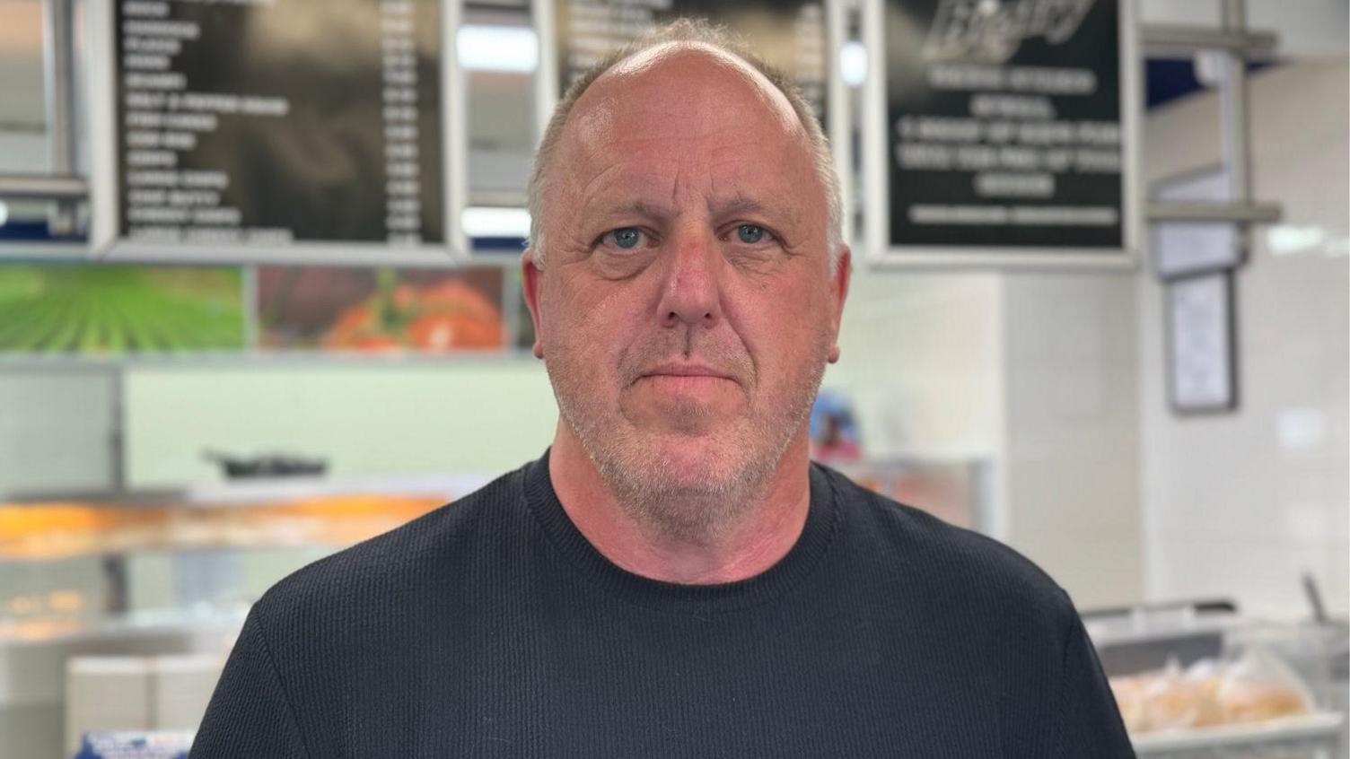 A man in a black t-shirt.
