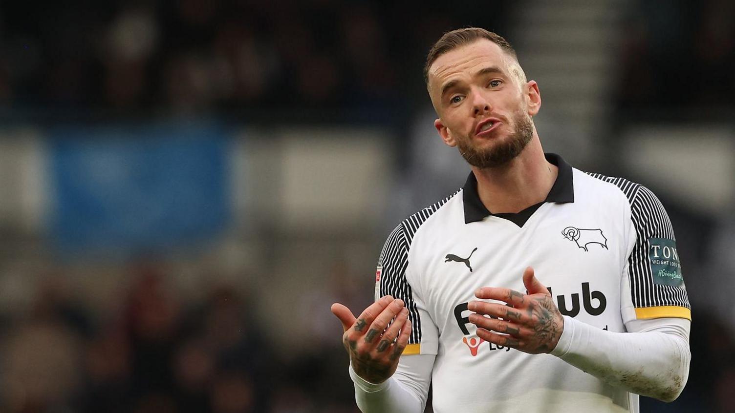 Derby's Joe Ward making hand gestures in front of himself during a match