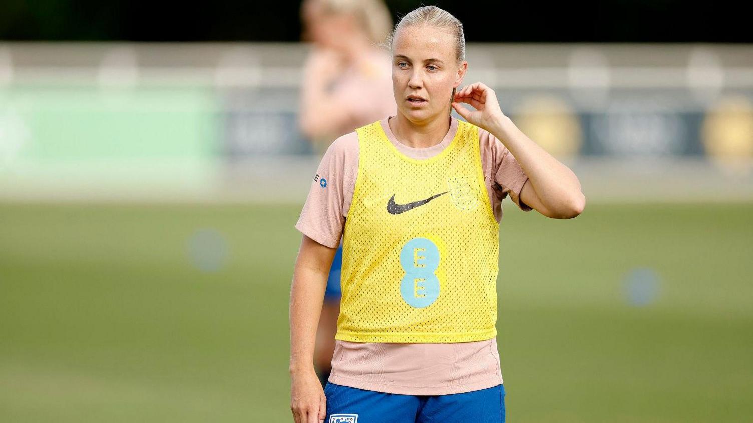 Beth Mead wearing a yellow vest during training