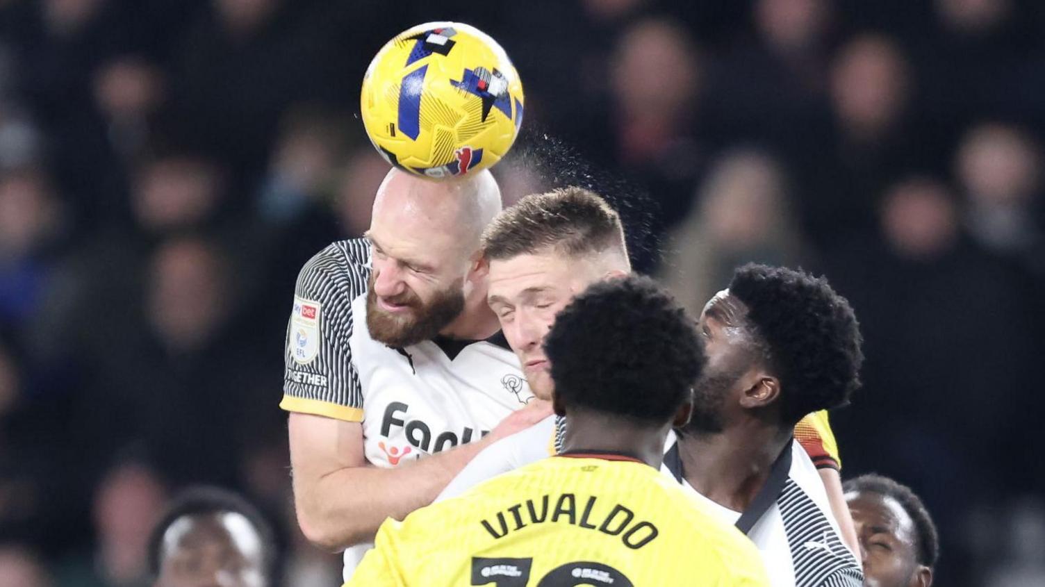 Derby County's Matt Clarke rises highest to win a header against Watford.