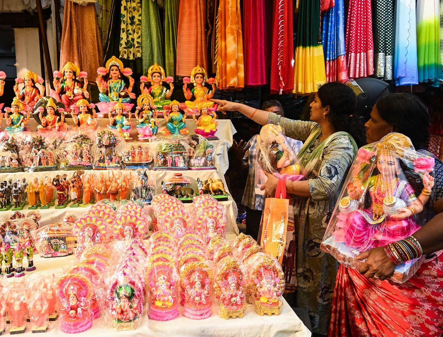 People buy idols of Hindu goddess Lakshmi and other gods at a market in Hyderabad