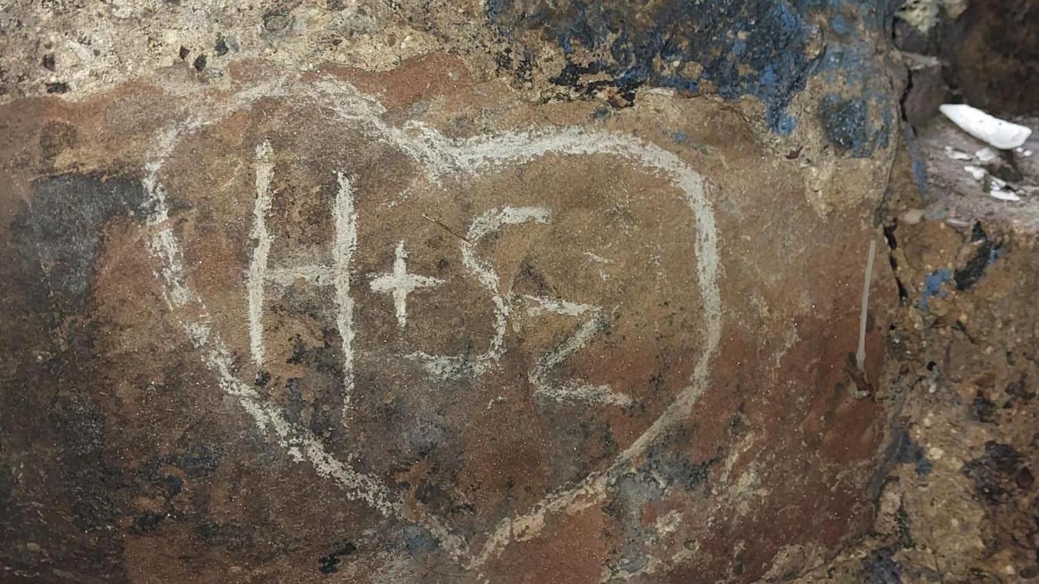 Letters carved into the monument walls