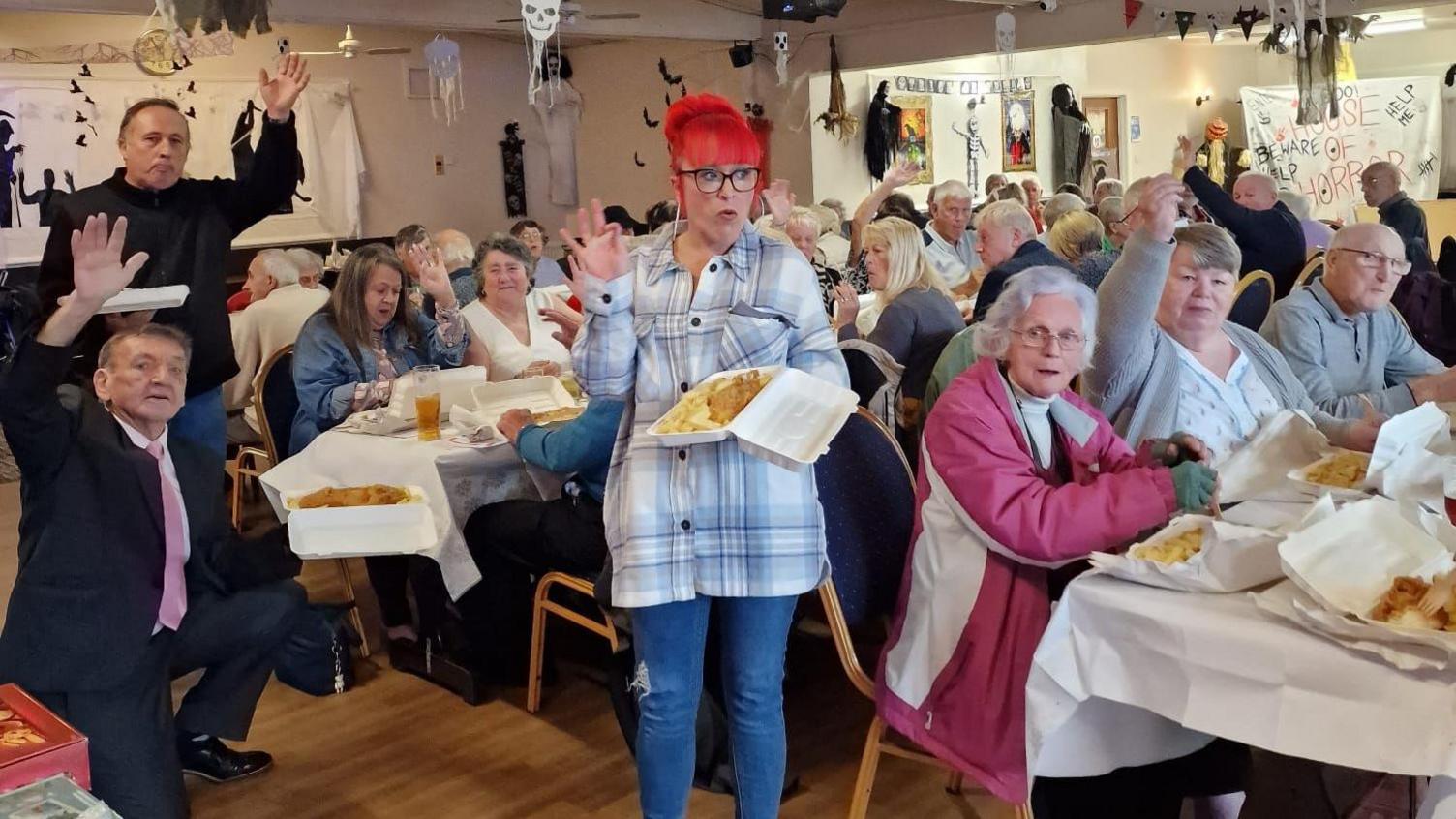 Colchester city councillor Dave Harris with pensioners at a fish and chip supper in the city