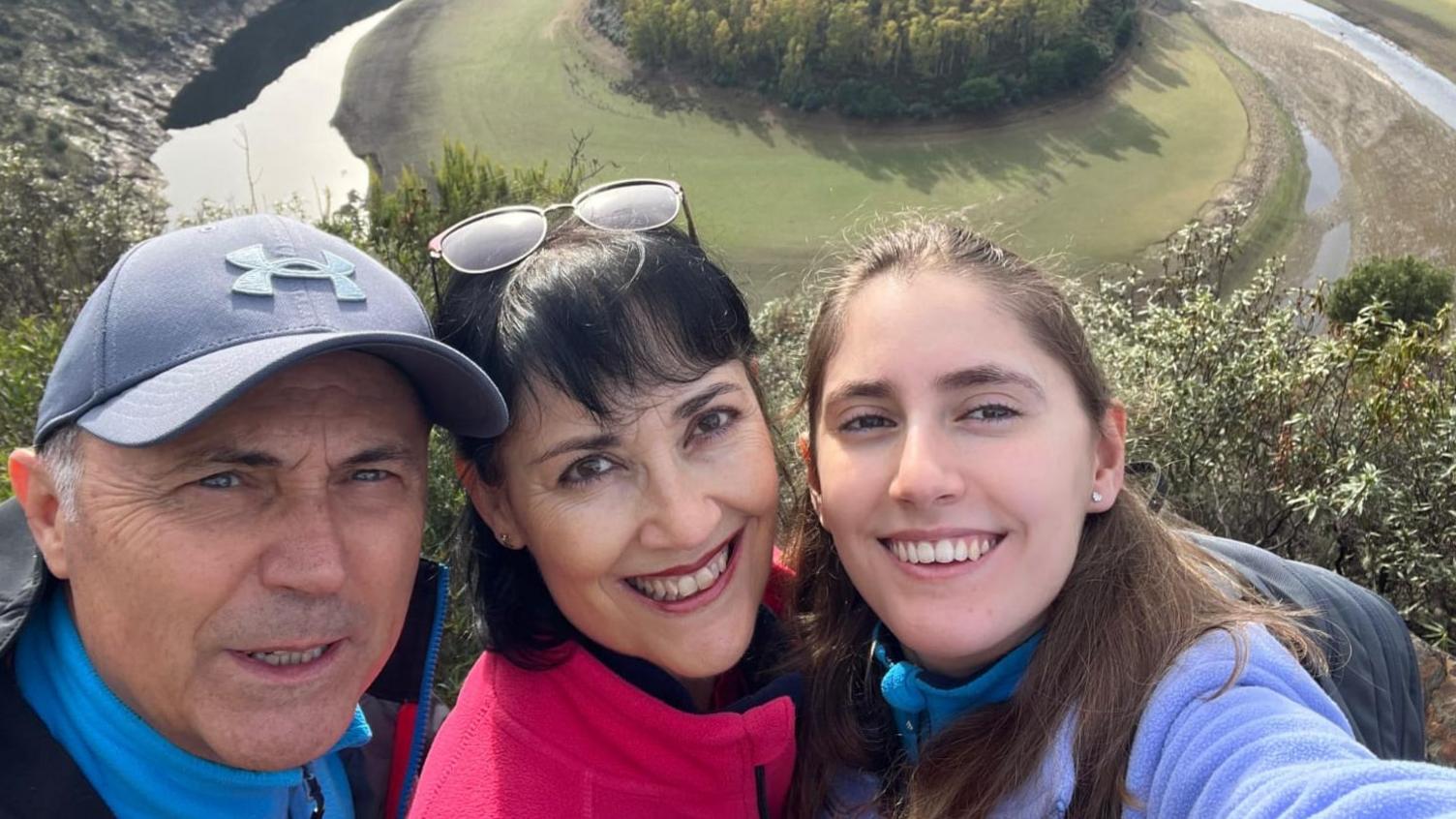 A selfie of a man, a woman and a young woman