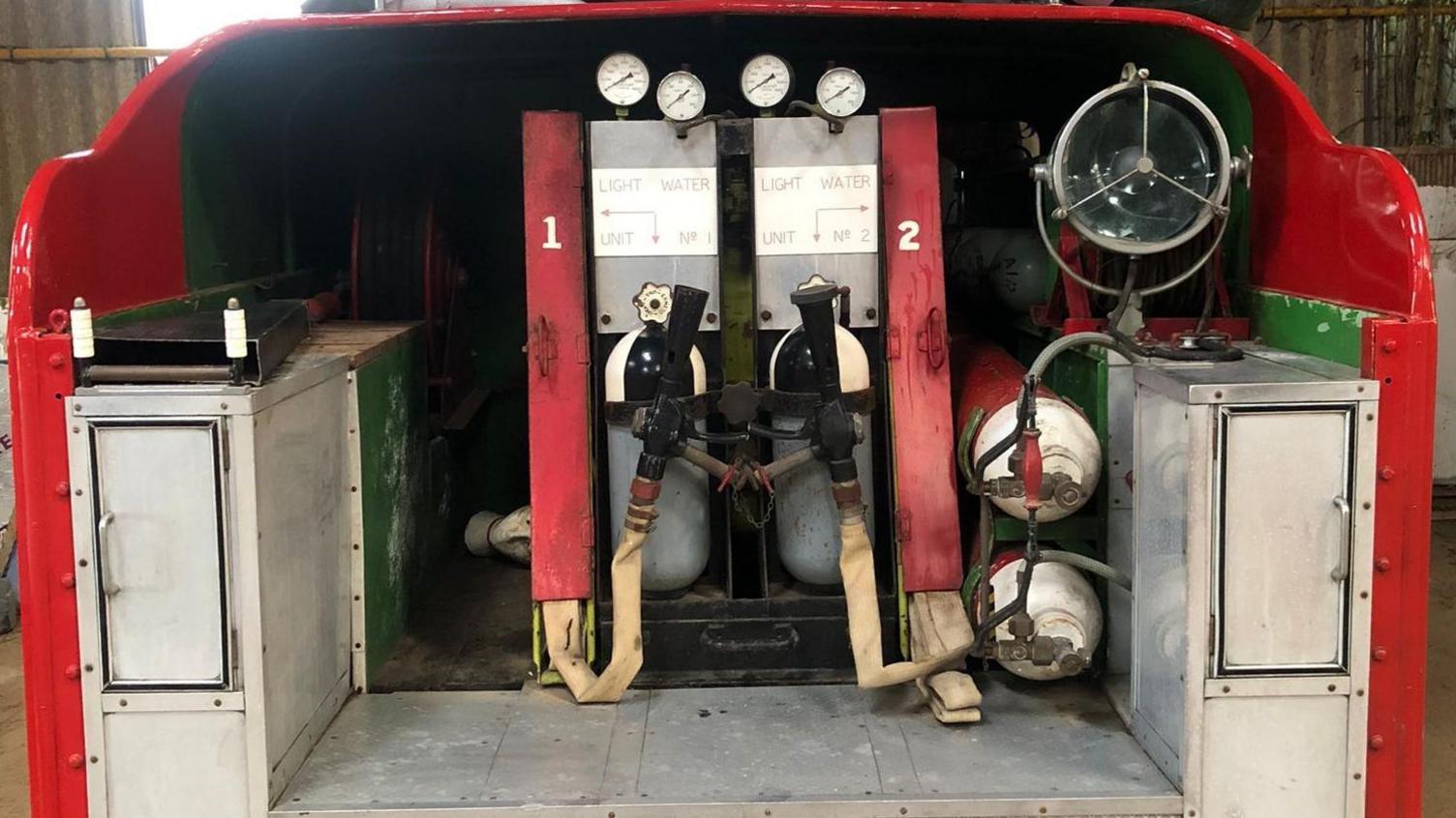 The back of the vehicle, which has various tanks, cupboards and levers.