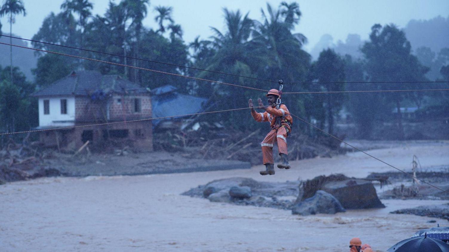 Members of rescue teams conduct rescue operation at a landslide site after multiple landslides in the hills in Wayanad