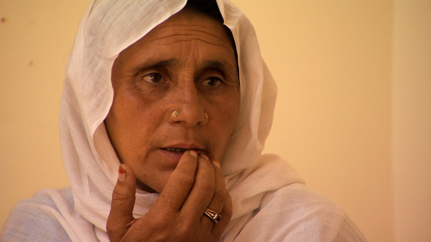 A old woman wearing a white headscarf